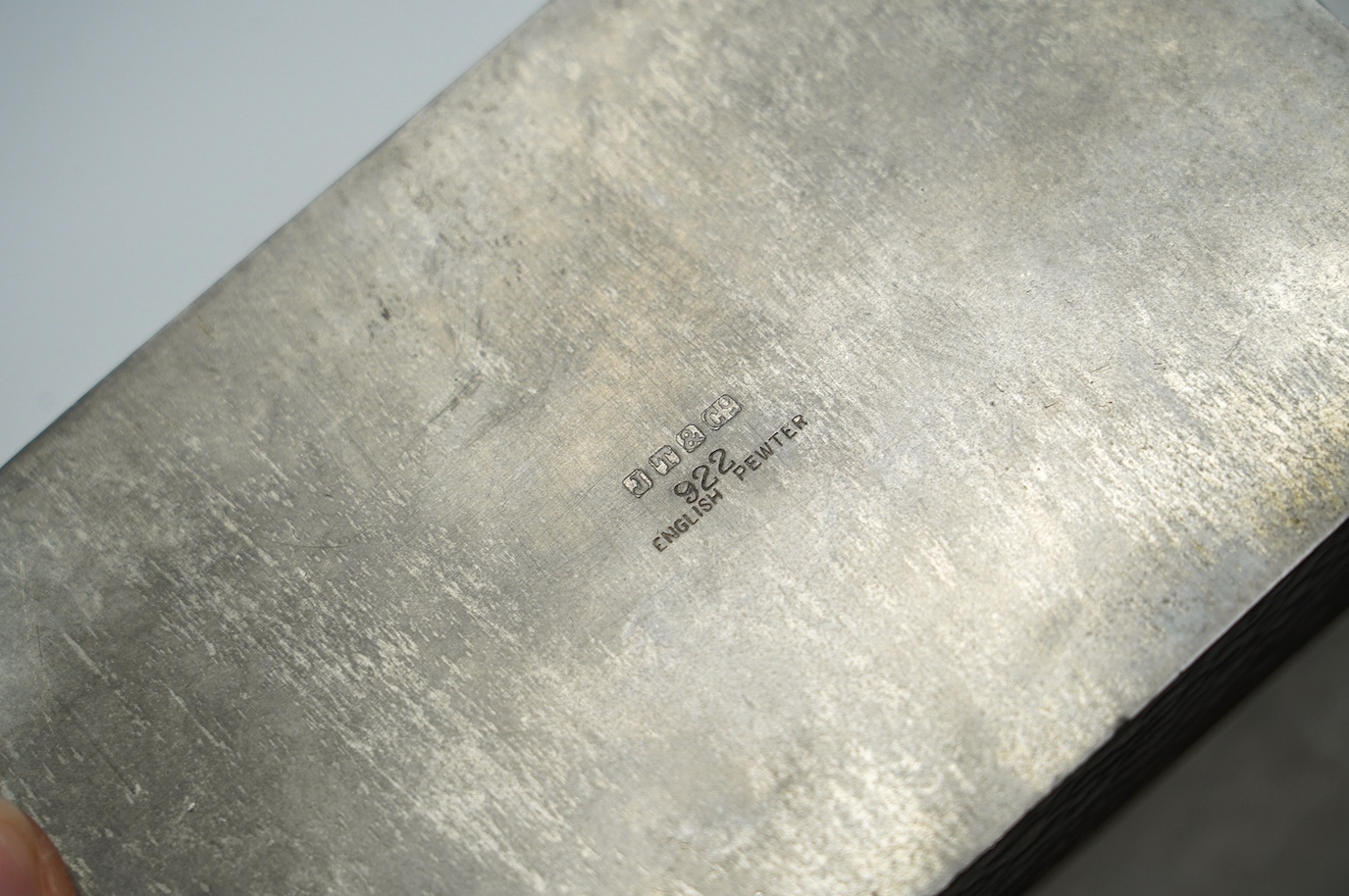 Two pewter cigarette boxes including a Liberty Tudric hammered form, largest 17.5cm wide. Condition - good